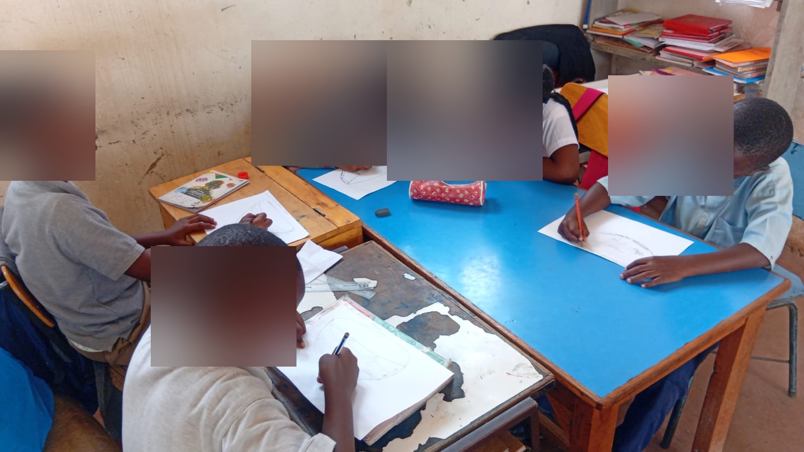 Learners engaged in a classroom drawing activity